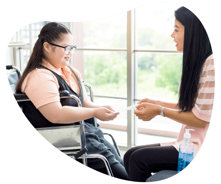 Two women engaged in conversation about NDIS daily tasks/shared living Two women engaged in conversation about NDIS daily tasks/shared living