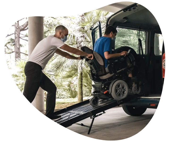 NDIS registered provider in South East Melbourne assisting a person in a wheelchair to board a van.